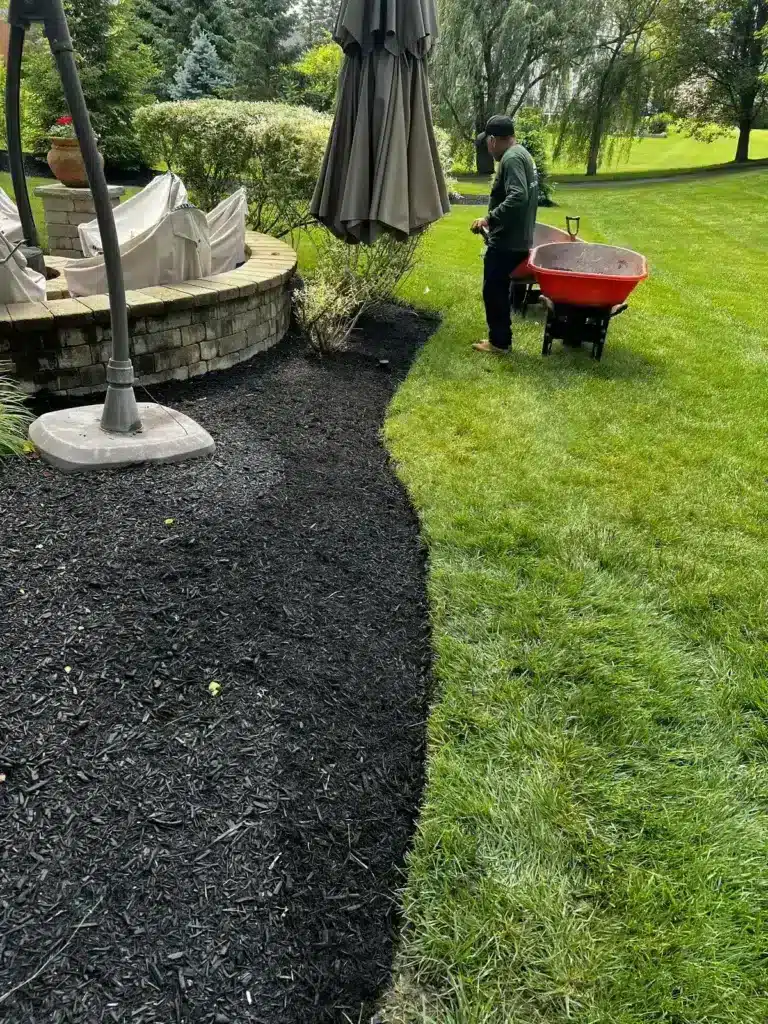 Spring cleanup and fresh mulch around a patio