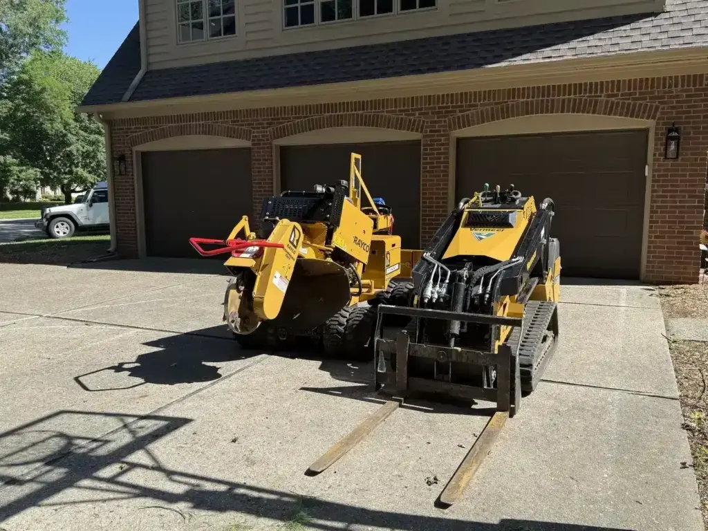 Anthony's stump grinder and mini skid steer on a job in Carmel, IN