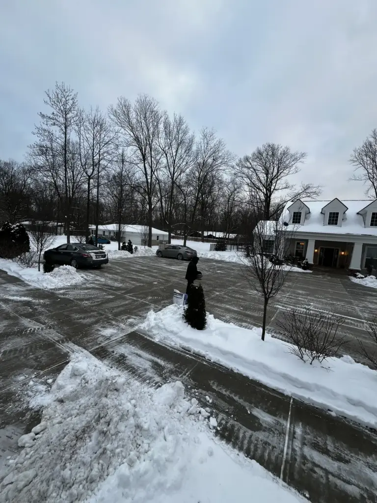 Commercial parking lot plowed with snow piled at the edges in Carmel, IN
