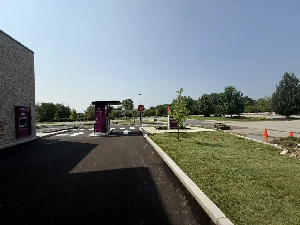 Fresh lawn beside a commercial building and parking lot in Carmel, IN
